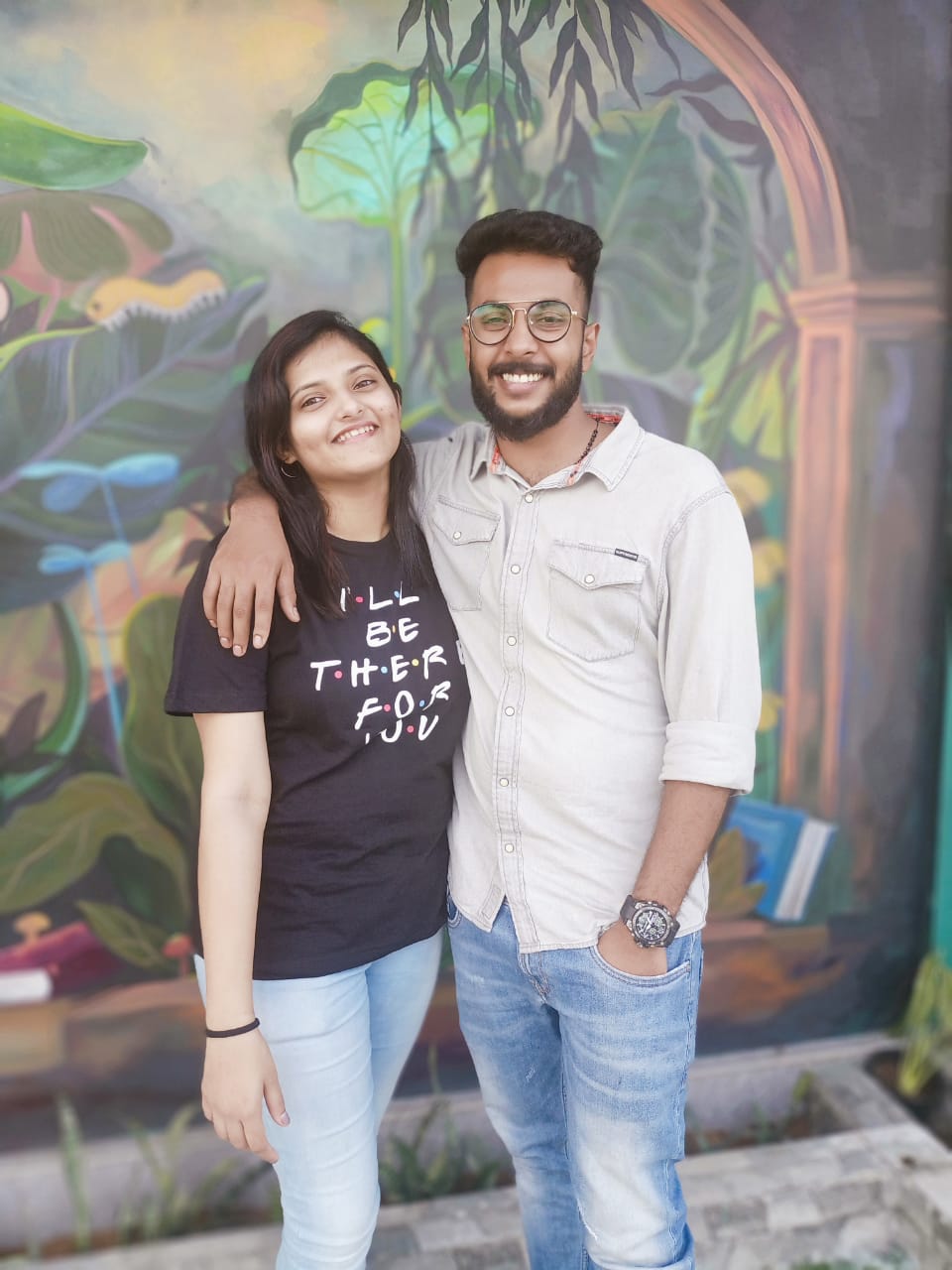 In front of the painted mural wall